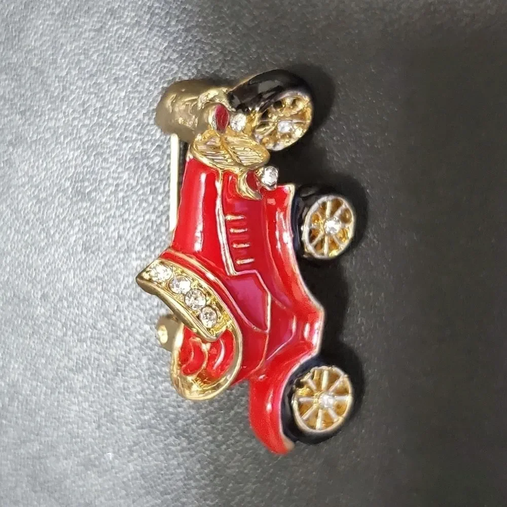 Gold tone red enamel antique car brooch